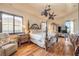 Spacious Primary bedroom with wooden floors, ceiling fans, and views of the backyard at 610 Mura Ct, New Smyrna Beach, FL 32168