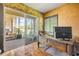 Office space with hardwood flooring, desk and a sliding glass door that leads to an outside patio area at 610 Mura Ct, New Smyrna Beach, FL 32168