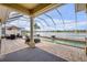 Large screened patio featuring a pool, dining area, and lounge chairs, ideal for outdoor enjoyment and lakeside living at 610 Mura Ct, New Smyrna Beach, FL 32168