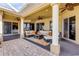Expansive patio with seating, ceiling fans, and brick pavers provides a perfect space for outdoor entertaining at 610 Mura Ct, New Smyrna Beach, FL 32168