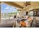 Screened patio with wicker furniture, ceiling fans, and pool access offers serene outdoor living and stunning lake views at 610 Mura Ct, New Smyrna Beach, FL 32168