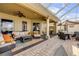 Spacious covered patio featuring a seating area, grill, and dining set, ideal for outdoor living and relaxation at 610 Mura Ct, New Smyrna Beach, FL 32168