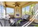 Cozy covered patio with a fireplace, seating, and a lake view, perfect for relaxing and enjoying the outdoors at 610 Mura Ct, New Smyrna Beach, FL 32168