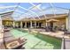 Aerial view of a screened pool and patio, with ample lounging space and lush landscaping, perfect for outdoor enjoyment at 610 Mura Ct, New Smyrna Beach, FL 32168