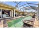 Covered patio with a pool, offers a seamless indoor-outdoor living experience, perfect for entertaining and relaxation at 610 Mura Ct, New Smyrna Beach, FL 32168