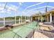 Relaxing screened-in pool and spa featuring lake views and an outdoor fireplace at 610 Mura Ct, New Smyrna Beach, FL 32168
