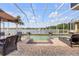 Stunning screened-in pool area overlooking a serene lake and featuring lounge seating at 610 Mura Ct, New Smyrna Beach, FL 32168