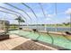 Screened pool and patio area with a built-in spa offer a private outdoor oasis with tranquil water views at 610 Mura Ct, New Smyrna Beach, FL 32168