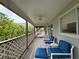 Spacious balcony with weathered wood and lattice details with comfortable seating and nice views at 6361 Turtlemound Rd, New Smyrna Beach, FL 32169