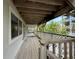Long balcony with weathered wood and lattice details with nice views at 6361 Turtlemound Rd, New Smyrna Beach, FL 32169