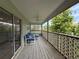 Spacious balcony with weathered wood and lattice details with comfortable seating and nice views at 6361 Turtlemound Rd, New Smyrna Beach, FL 32169