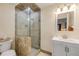 Modern bathroom with tiled walk-in shower, a white vanity, and updated lighting fixtures at 6361 Turtlemound Rd, New Smyrna Beach, FL 32169