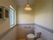 Bathroom featuring a toilet and window at 6361 Turtlemound Rd, New Smyrna Beach, FL 32169