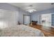 Spacious bedroom with a ceiling fan, closet, wood floors and French doors leading to another room at 6361 Turtlemound Rd, New Smyrna Beach, FL 32169