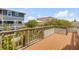 Large deck area with views of the neighborhood, palm trees, and swimming pool at 6361 Turtlemound Rd, New Smyrna Beach, FL 32169
