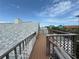 Spacious rooftop deck with wooden railings offers panoramic views of the surrounding neighborhood and the sky at 6361 Turtlemound Rd, New Smyrna Beach, FL 32169