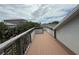 Wide rooftop deck with wooden railings and ample space for outdoor seating and lounging, providing a private retreat at 6361 Turtlemound Rd, New Smyrna Beach, FL 32169