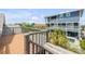 Spacious deck overlooking the community, nearby pool, and lush palm trees at 6361 Turtlemound Rd, New Smyrna Beach, FL 32169