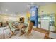 Open-concept dining area featuring a fireplace and seating for four, bathed in bright, natural light at 6361 Turtlemound Rd, New Smyrna Beach, FL 32169