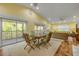 Bright dining area with ample natural light, a charming table, and a cozy sofa at 6361 Turtlemound Rd, New Smyrna Beach, FL 32169