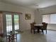 Light-filled dining room featuring a table with four chairs and natural light from windows and French doors at 6361 Turtlemound Rd, New Smyrna Beach, FL 32169