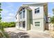 Inviting two-story home with a well-manicured lawn, mature landscaping, and a private driveway at 6361 Turtlemound Rd, New Smyrna Beach, FL 32169