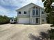 Charming two-story home featuring a spacious driveway and an attached garage at 6361 Turtlemound Rd, New Smyrna Beach, FL 32169