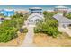 Charming two-story beach home featuring lush tropical landscaping and ample parking at 6361 Turtlemound Rd, New Smyrna Beach, FL 32169