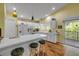 Bright kitchen with white cabinets, breakfast bar with stools, and modern appliances, perfect for cooking and dining at 6361 Turtlemound Rd, New Smyrna Beach, FL 32169