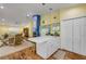 An open-concept kitchen and living area featuring a center island, a fireplace, and wood floors at 6361 Turtlemound Rd, New Smyrna Beach, FL 32169