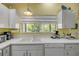 Bright kitchen featuring white cabinets and essential appliances at 6361 Turtlemound Rd, New Smyrna Beach, FL 32169
