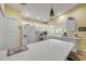 Well-lit kitchen featuring white cabinets, breakfast bar, and modern appliances for cooking and dining experience at 6361 Turtlemound Rd, New Smyrna Beach, FL 32169
