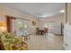 Open living area with tile flooring, French doors to patio, and adjacent dining area at 6361 Turtlemound Rd, New Smyrna Beach, FL 32169