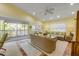 Inviting living room with large windows, comfortable wicker furniture, and serene tropical decor accents at 6361 Turtlemound Rd, New Smyrna Beach, FL 32169
