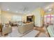 Bright living room with entertainment center, wicker furniture, and seamless access to other areas of the house at 6361 Turtlemound Rd, New Smyrna Beach, FL 32169