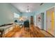 Bright living room featuring hardwood floors, ceiling fan, and comfortable seating arrangement at 6361 Turtlemound Rd, New Smyrna Beach, FL 32169