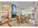 Open-concept living and dining area features a fireplace and a modern kitchen with bar seating at 6361 Turtlemound Rd, New Smyrna Beach, FL 32169