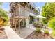 Exterior view featuring a patio area with an outdoor dining table, stairs, and garden at 6361 Turtlemound Rd, New Smyrna Beach, FL 32169