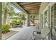 Inviting outdoor patio with dining set, greenery, and easy access to the upper deck at 6361 Turtlemound Rd, New Smyrna Beach, FL 32169