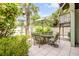 Outdoor patio area with dining set, umbrella, and views of the lush garden at 6361 Turtlemound Rd, New Smyrna Beach, FL 32169