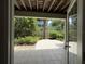 Relaxing patio area with tiled flooring, open views, and tranquil landscaping at 6361 Turtlemound Rd, New Smyrna Beach, FL 32169