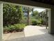 Relaxing patio area with tiled flooring, open views, and tranquil landscaping at 6361 Turtlemound Rd, New Smyrna Beach, FL 32169