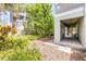 Exterior view of the patio area, lush landscaping, and home features at 6361 Turtlemound Rd, New Smyrna Beach, FL 32169