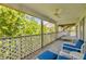 Inviting porch with outdoor seating and a ceiling fan for comfortable relaxation at 6361 Turtlemound Rd, New Smyrna Beach, FL 32169
