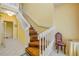 Staircase with wood treads, white railings and a cozy chair at 6361 Turtlemound Rd, New Smyrna Beach, FL 32169