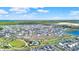 Wide aerial view of a neighborhood featuring a community pool and green spaces at 6542 Rover Way, St Cloud, FL 34771