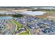 Aerial view of a new development featuring a community pool and lush landscaping at 6542 Rover Way, St Cloud, FL 34771