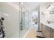 Bathroom with glass-enclosed shower, large format tile and view into the main bedroom suite at 6542 Rover Way, St Cloud, FL 34771