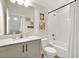 Well-lit bathroom featuring a vanity with stone countertop and a shower-tub combo with curtain at 6542 Rover Way, St Cloud, FL 34771