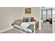 Cozy bedroom featuring daybed with decorative pillows and artwork, leading to a secondary living area with couch at 6542 Rover Way, St Cloud, FL 34771
